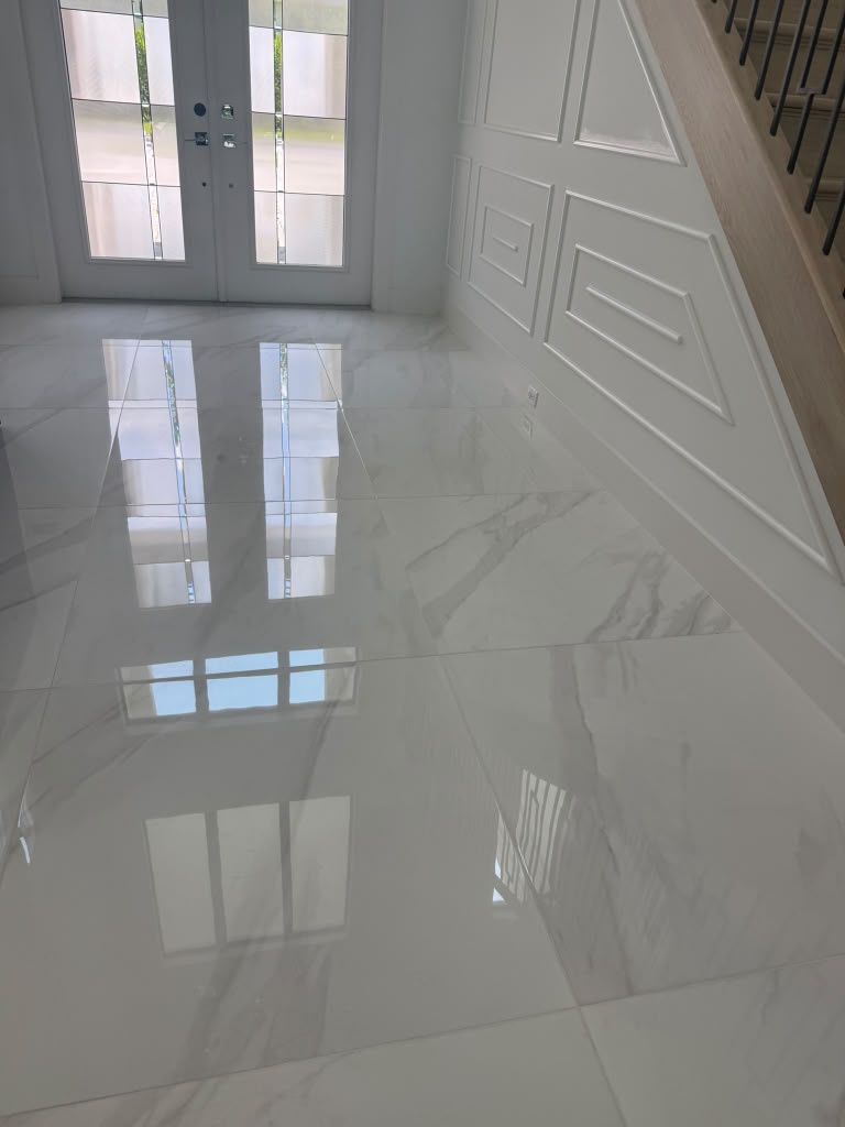 Clean reflective tile flooring in residential entryway